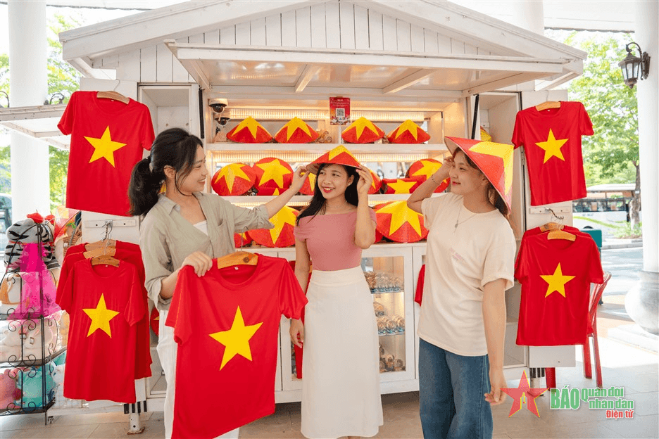 Du khách đội nón lá, mặc áo in màu cờ Tổ quốc check-in Ba Na Hills